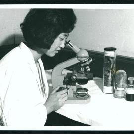 Medical Student Using Microscope