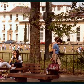 Students with the Square and Physics Building Behind