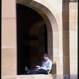 Student Sitting in Quadrangle Cloisters