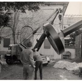A Crane Lifts a Mushroom Shaped "Scintillator Tank" Into Place at the University